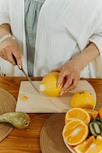 food-wood-person-woman-7530827 A woman cutting lemons in the kitchen, preparing fresh juice.